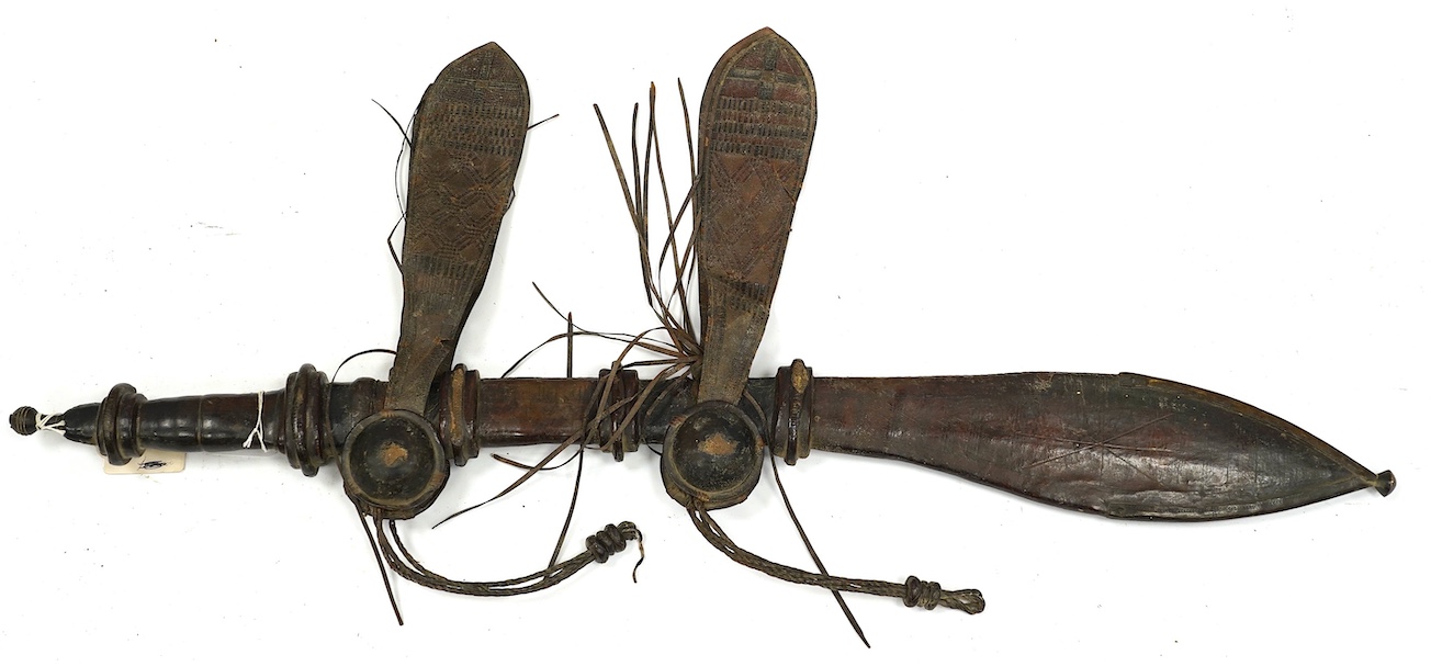 A late 19th century Nigerian Taboura from the Hausa People of Northern Nigeria, in leather scabbard, blade 55.5cm. Condition - good